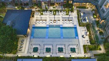 an aerial view of resort style pool at night at The Hendrix, Georgia